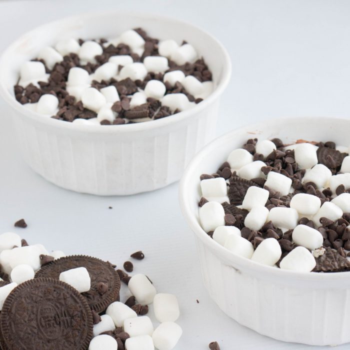 Oreos, chocolate, and marshmallows combine in this amazing Cookies n' Cream Oreo Lush dessert. Layers of yummy flavor in each bite. It all starts with an Oreo crust and then add a cream cheese layer, chocolate pudding, and marshmallow fluff with whip cream topping. 