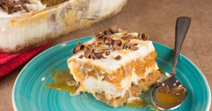 Butterscotch Lush is a 4-layer dessert of graham cracker crust, cream cheese, pudding, and whipped cream. Topped with butterscotch and chocolate shavings.