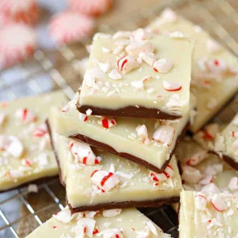 A Christmas favorite, this layered white chocolate peppermint fudge is perfect for holiday parties and gifting! Enjoy the layers of chocolate and white chocolate topped with crushed candy canes.