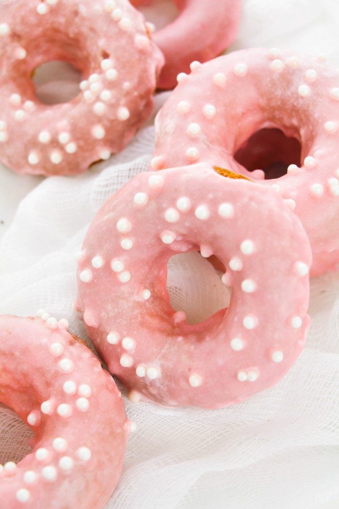 Easy Strawberry Frosted Donuts recipe -- Complete with a fresh strawberry glaze to top this simple baked donuts. The perfect pick-me-up after a long week or just because! Add this classic to your breakfast recipes.