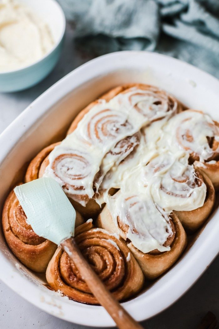 Sourdough Cinnamon Rolls being frosted