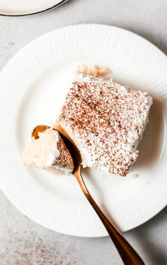 Tres Leches Poke Cake with spoonful
